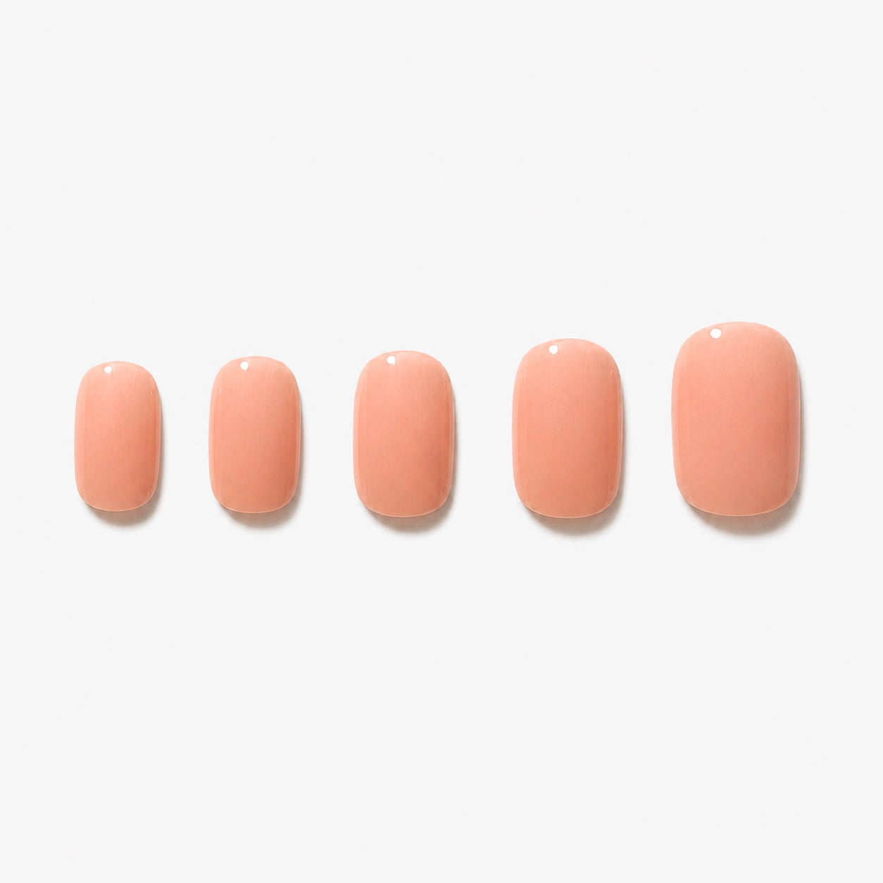 Faux ongles press-on courts arrondis Nude Abricot Soimea, teinte nude pêche glossy pour manucure naturelle et élégante