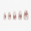 Faux ongles press-on Stella Marina longs amande blanc lacté avec étoiles de mer en paillettes or orangé inspirées de la plage