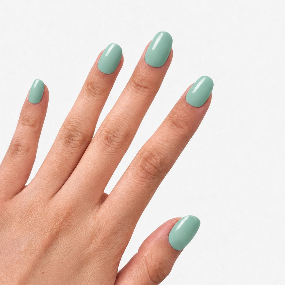 Manucure press-on Vert Menthe portée sur la main, faux ongles courts arrondis vert pastel brillant et frais